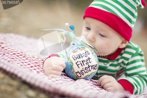Image of Infant Baby On Blanket With Babys First Christmas Ornament