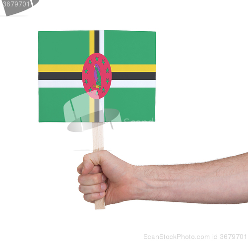 Image of Hand holding small card - Flag of Dominica