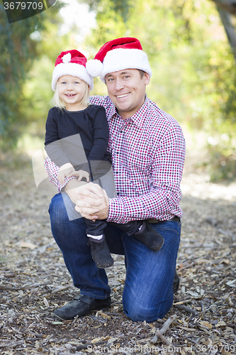 Image of Portrait of Father and Daughter Wearing Santa Hats