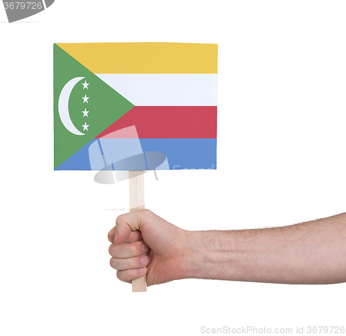 Image of Hand holding small card - Flag of Comoros