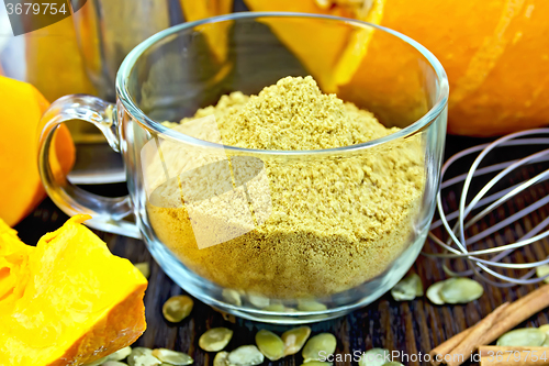 Image of Flour pumpkin in glass cup with seeds and a mixer on board