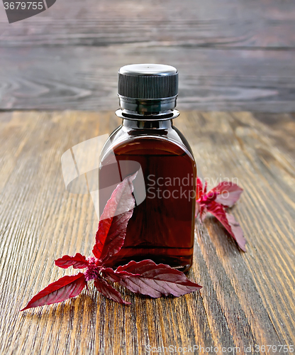 Image of Oil with amaranth on dark board