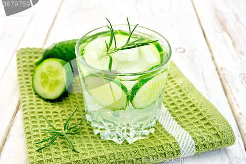 Image of Lemonade with cucumber and rosemary in glassful on napkin