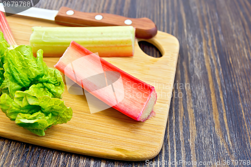 Image of Rhubarb with knife on board