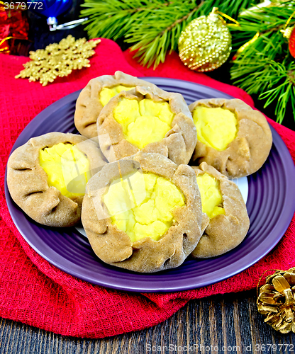 Image of Carols with potatoes on red napkin with Christmas toys