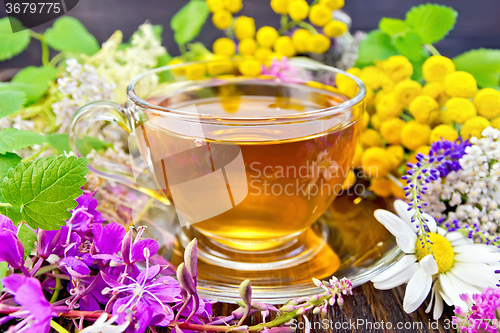 Image of Tea from flowers in glass cup on board