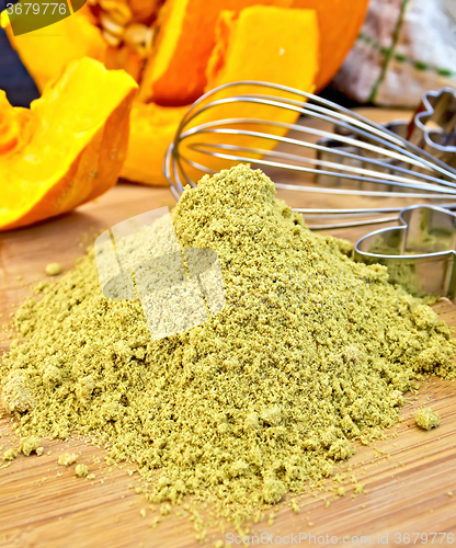 Image of Flour pumpkin with mixer and sieve on board