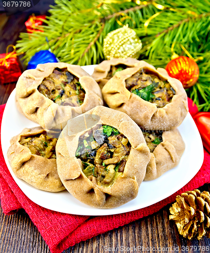 Image of Carols with mushrooms on red napkin with Christmas toys