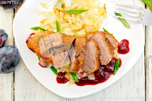 Image of Duck breast with cabbage and green onions in plate