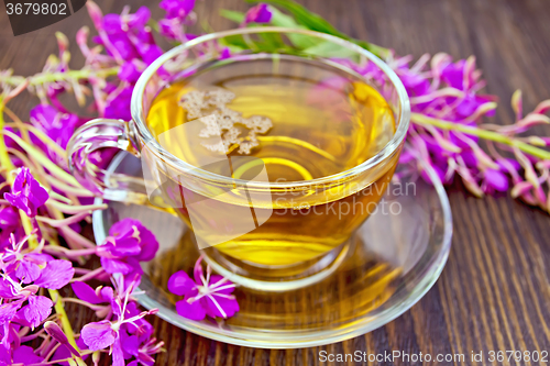 Image of Tea from fireweed in glass cup on board