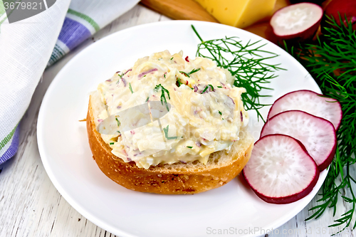 Image of Appetizer of radish and cheese on bun in plate with napkin