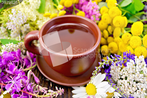 Image of Tea from flowers in clay cup on board