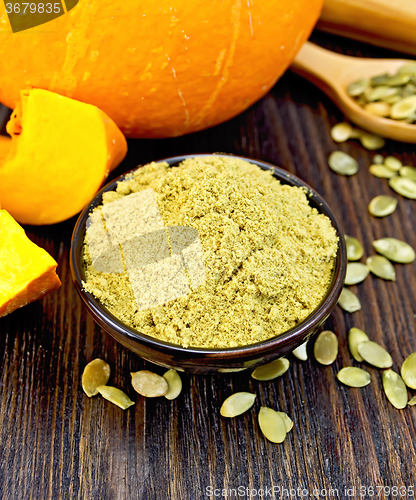 Image of Flour pumpkin in bowl with seeds and spoon on board