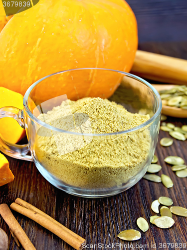 Image of Flour pumpkin in glass cup with seeds on board