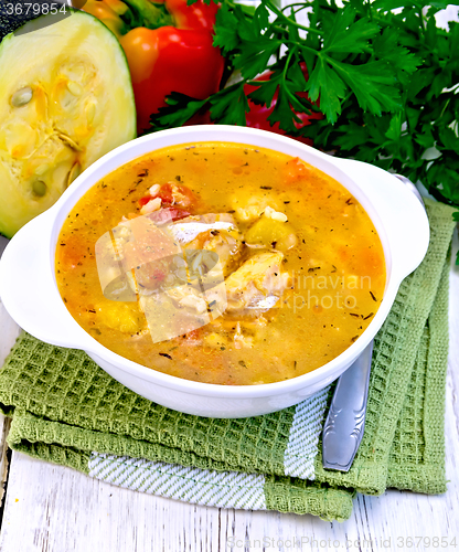 Image of Soup fish with zucchini and peppers on light board