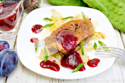 Image of Duck breast whole with plum sauce and cabbage in plate