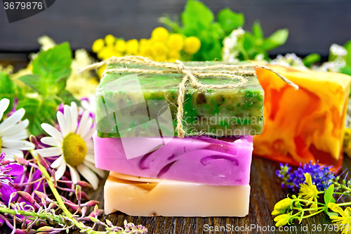 Image of Soap homemade with flowers and leaves on board