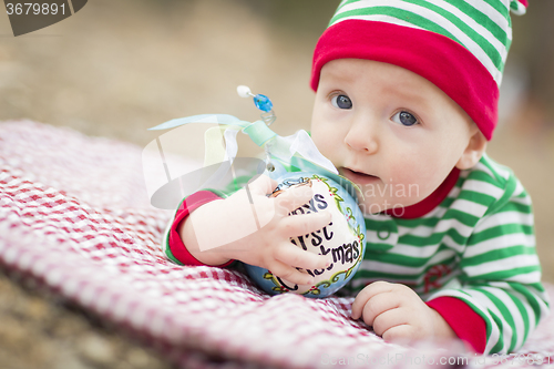 Image of Infant Baby On Blanket With Babys First Christmas Ornament