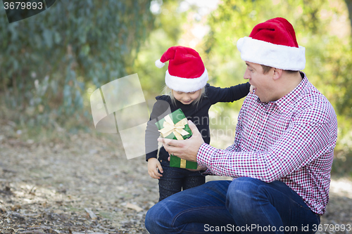 Image of Father Giving Young Daughter Christmas Gift