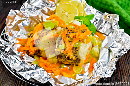 Image of Pike with carrots in foil on board