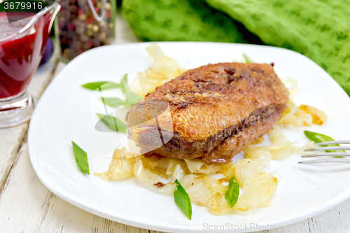 Image of Duck breast whole with cabbage and green onions in plate