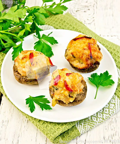 Image of Champignons stuffed meat in white plate on napkin