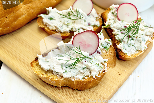 Image of Bread with pate of curd and radish on light board