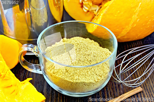 Image of Flour pumpkin in glass cup with mixer on board