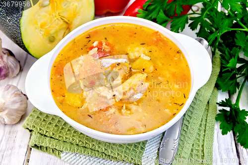 Image of Soup fish with zucchini and peppers on napkin