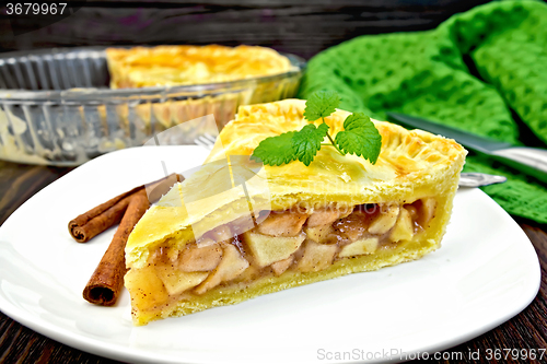 Image of Pie apple with mint in plate on dark board