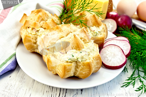 Image of Appetizer of radish and cheese in profiteroles on white plate