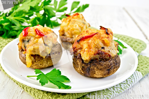 Image of Champignons stuffed meat in white plate on board