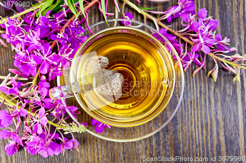 Image of Tea from fireweed in glass cup on board top