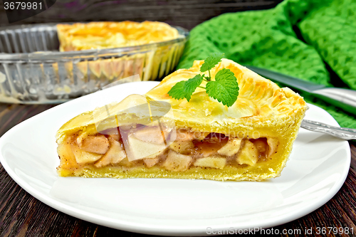 Image of Pie apple with mint in plate on board