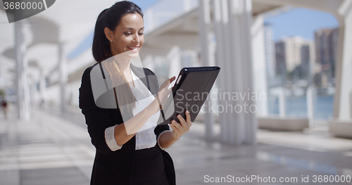 Image of Smiling woman surfing the internet