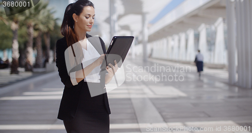 Image of Elegant businesswoman on a seafront promenade