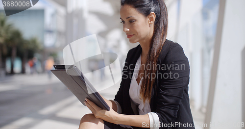 Image of Attractive businesswoman working on a tablet