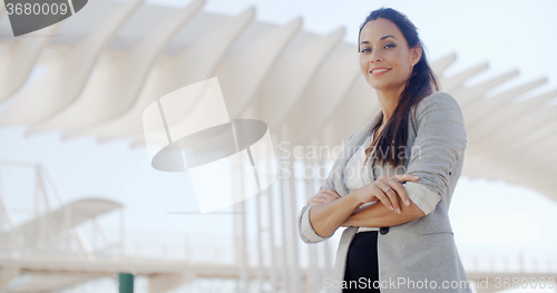 Image of Smiling stylish woman looking down at the camera