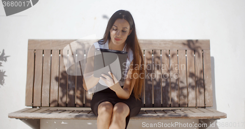 Image of Adorable Business Woman Working on Tablet