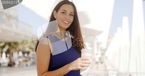 Image of Attractive woman holding a large cup of coffee