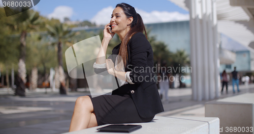 Image of Stylish young woman in a tropical town