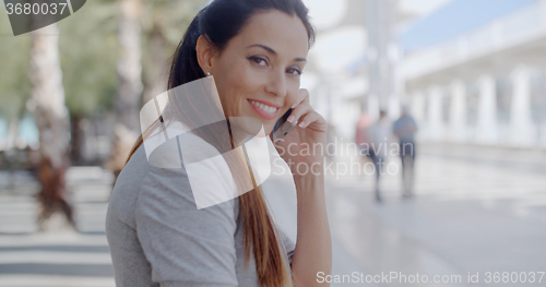 Image of Relaxed young woman talking on her mobile