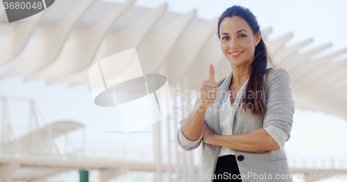 Image of Motivated young woman giving a thumbs up