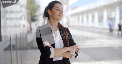 Image of Confident businesswoman standing waiting