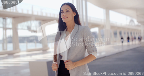 Image of Stylish woman with long hair standing on a mobile