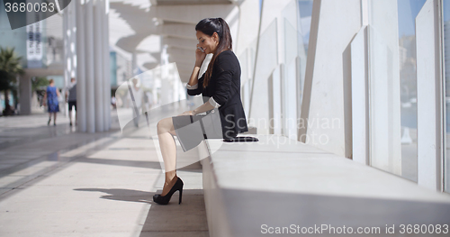 Image of Elegant businesswoman talking on her mobile