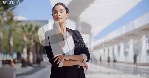 Image of Thoughtful businesswoman with folded arms