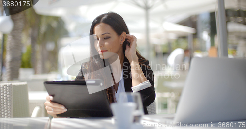 Image of Pretty stylish woman using her laptop
