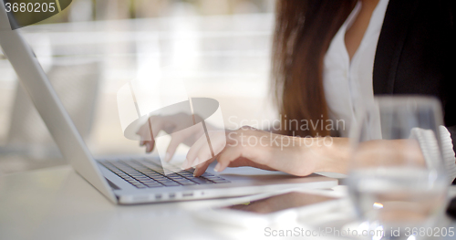 Image of Businesswoman typing on a laptop computer
