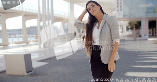 Image of Stylish woman with long hair standing on a mobile